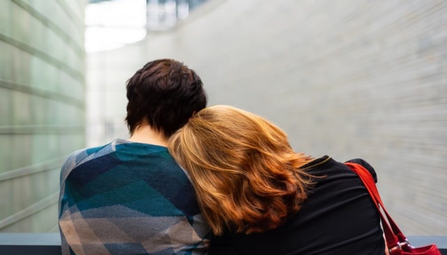 Women with head rested on someone's shoulder